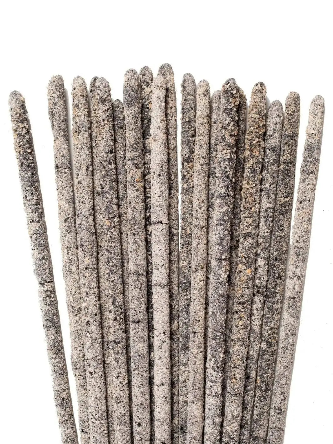 A detailed, close-up view focusing on the thick, textured, gray and white resin coated tips of several Amae Incense Copal Incense Sticks - Mayan Copal | Twentyseven Toronto