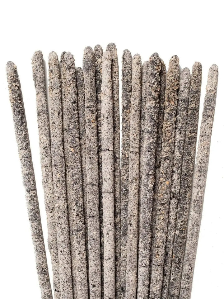 A detailed, close-up view focusing on the thick, textured, gray and white resin coated tips of several Amae Incense Copal Incense Sticks - Mayan Copal | Twentyseven Toronto