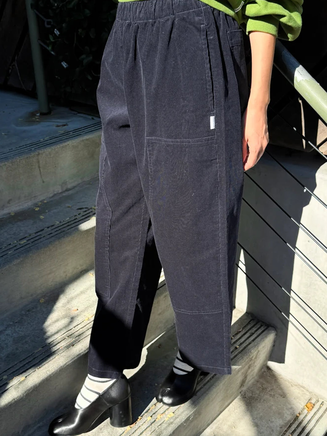 Side view of Le Bon Shoppe Corduroy Gardener's Pants in navy, highlighting the soft corduroy texture, relaxed silhouette and oversized carpenter-inspired patch pockets | Twentyseven Toronto