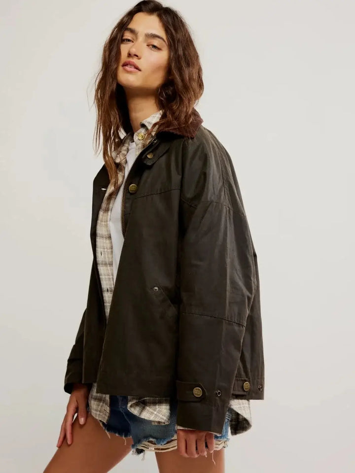 A three-quarter view shows the relaxed, oversized drape and pocket positioning of the Free People Cori Waxed Jacket in Olive | Twentyseven Toronto