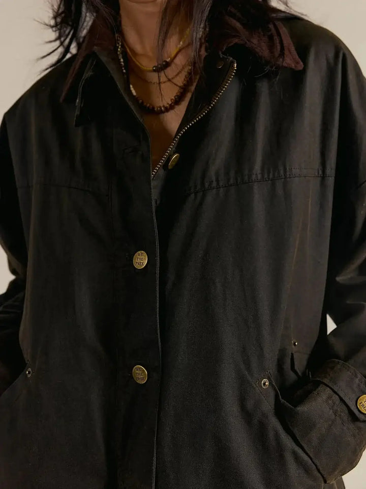 A detailed front-view image highlights the corduroy collar and button-down storm flap on the dark green Free People Cori Waxed Jacket in Olive | Twentyseven Toronto