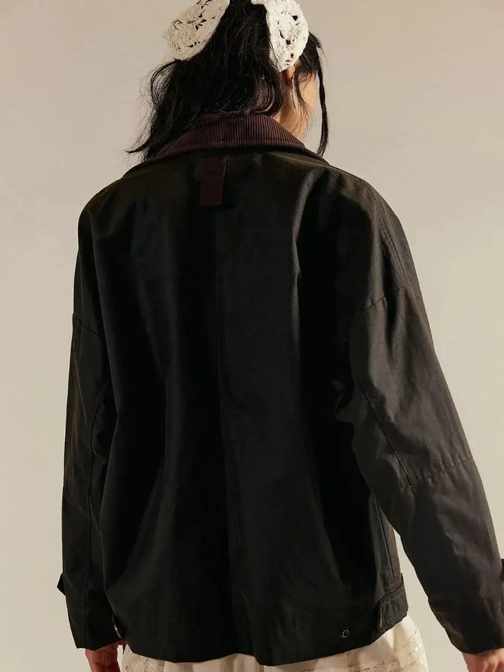 A rear view focuses on the brown corduroy collar and textured fabric backing of the Free People Cori Waxed Jacket in Olive | Twentyseven Toronto