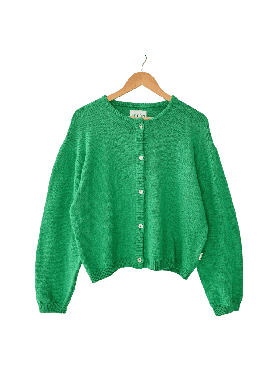 Le Bon Shoppe 'Cotton Leila Cardigan' in 'Spring Green' on a wooden hanger on transparent background | Twentyseven Toronto