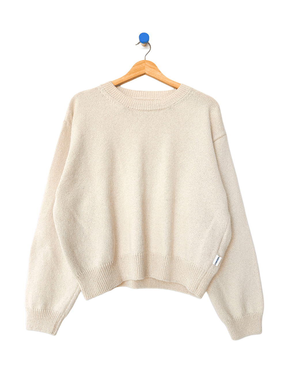 Le Bon Shoppe Milo Cotton Sweater in Natural on a wooden hanger | Twentyseven Toronto