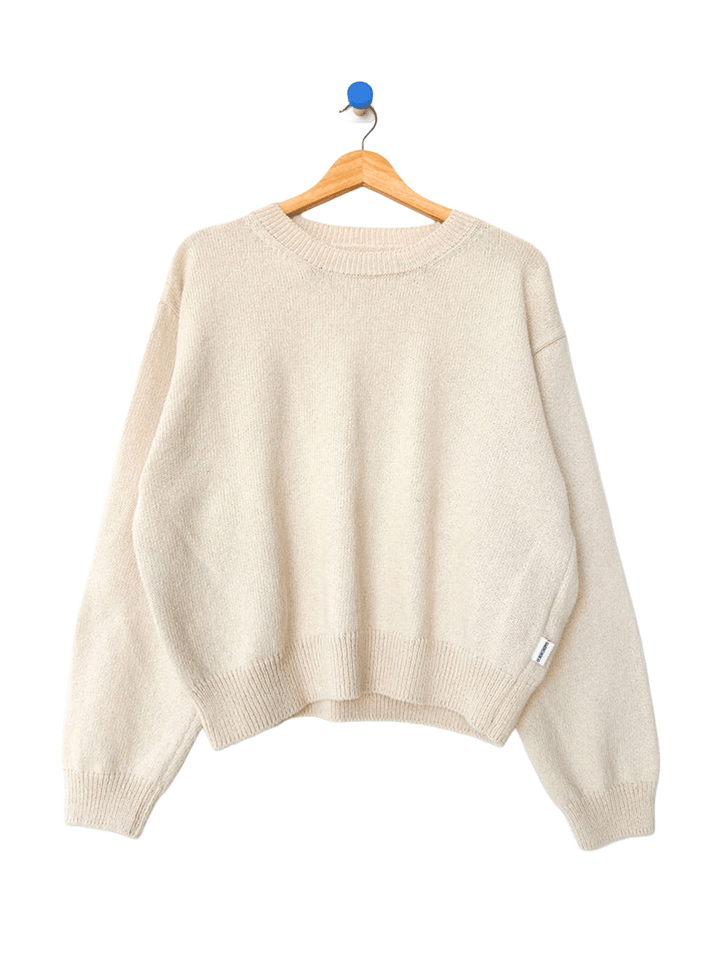 Le Bon Shoppe Milo Cotton Sweater in Natural on a wooden hanger | Twentyseven Toronto