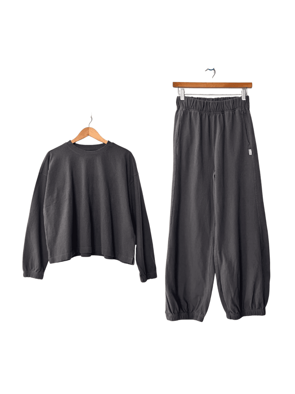 Dark grey Le Bon Shoppe 'Naturelle Tee' sweatshirt and 'Balloon Pants' in 'Dark Slate' set on hangers | Twentyseven Toronto