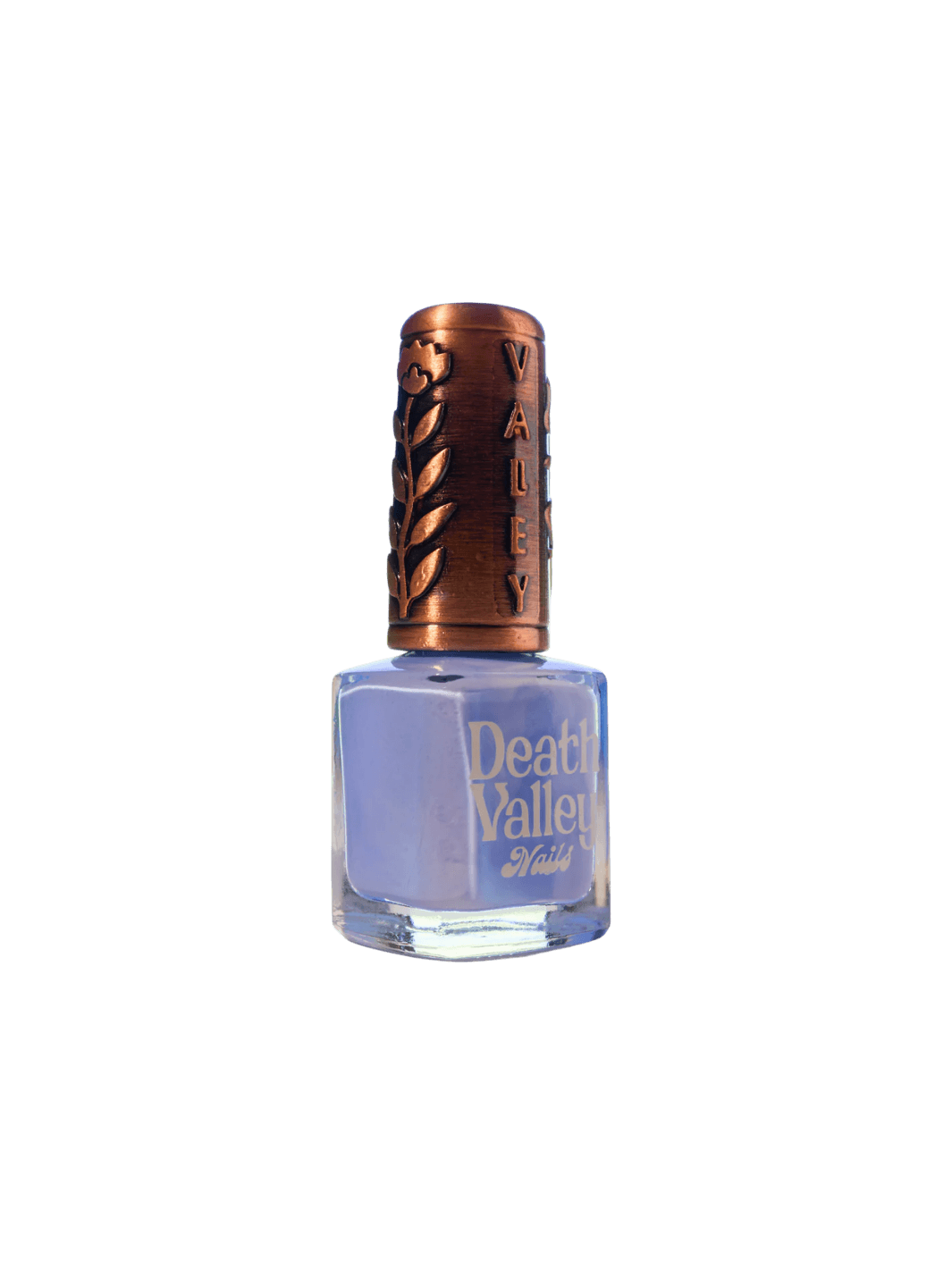 A bottle of Death Valley Nails Curiosity Cloud Nail Polish filled with light cornflower blue lacquer features a decorative copper-toned cap with an embossed floral and brand design | Twentyseven Toronto