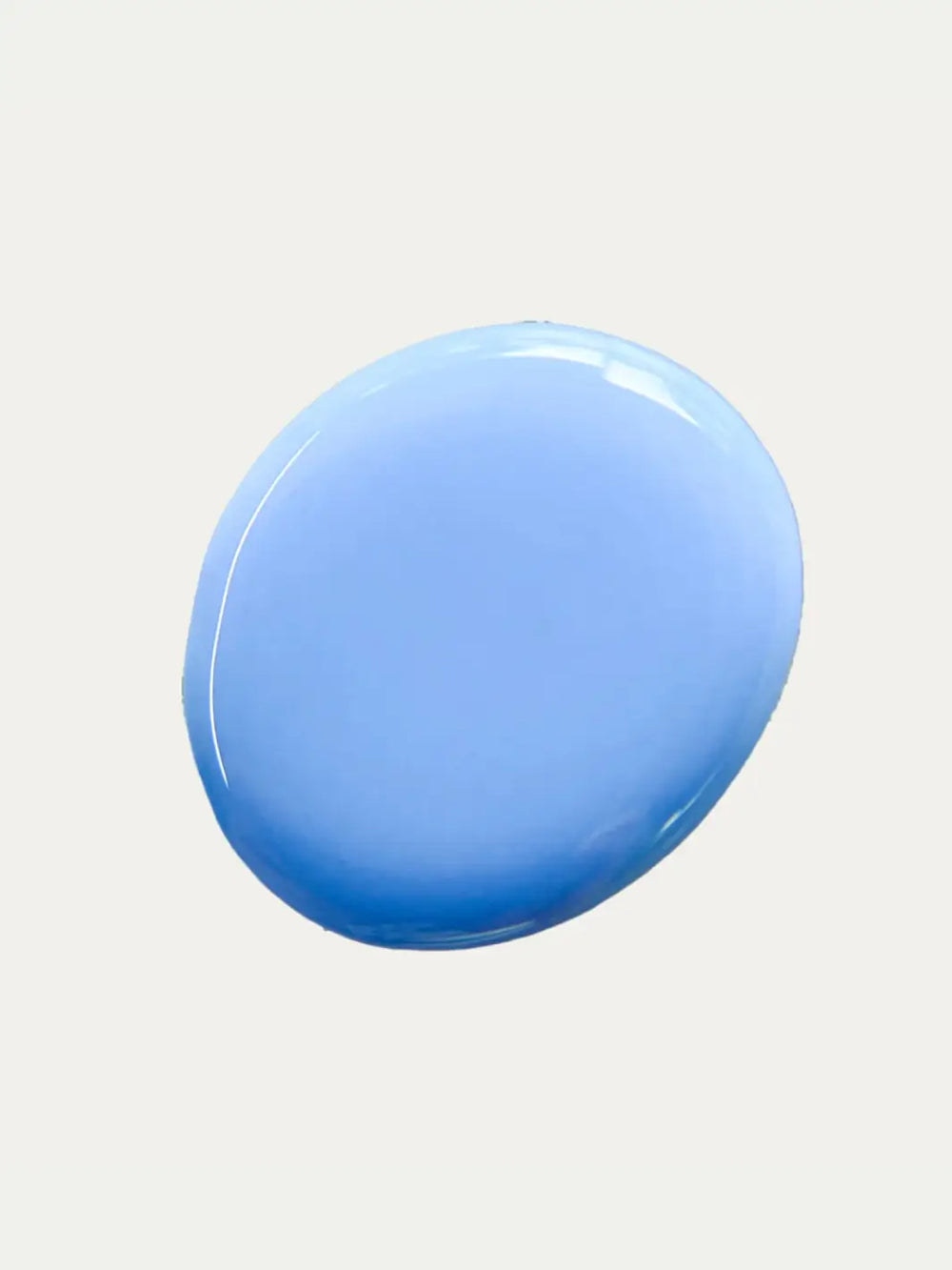 Circular color swatch shows the opaque, creamy light blue shade of Death Valley Nails Curiosity Cloud Nail Polish against a plain off-white background | Twentyseven Toronto
