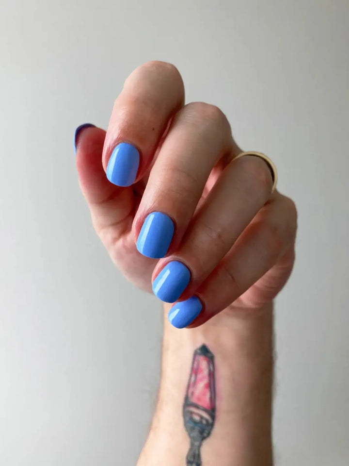 A hand with short, rounded nails displays light blue Death Valley Nails Curiosity Cloud Nail Polish | Twentyseven Toronto 