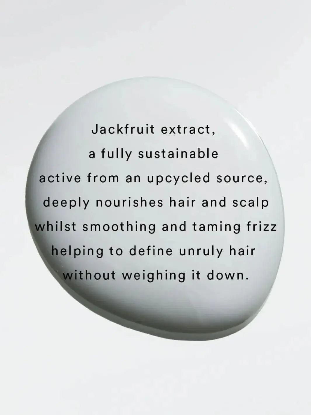 Black text layered over a smooth, white product droplet details the benefits of jackfruit extract, a key ingredient found in Hair by Sam McKnight Curl Cleanse Cleansing Conditioner | Twentyseven Toronto
