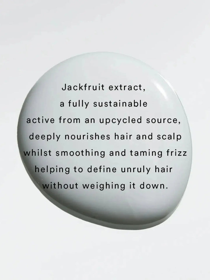 Black text layered over a smooth, white product droplet details the benefits of jackfruit extract, a key ingredient found in Hair by Sam McKnight Curl Cleanse Cleansing Conditioner | Twentyseven Toronto