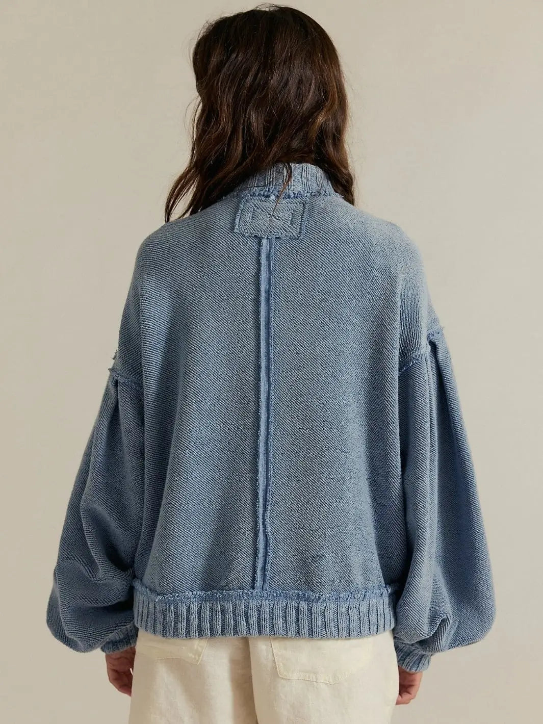 A back view captures the exposed seam detail, mock neck collar, and slouchy fit of the Free People Cute In This Cardi - Dusty Blue | Twentyseven Toronto