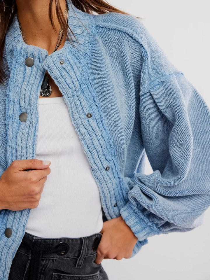 A detailed close-up shot emphasizes the heavy knit texture, snap-front placket, and gathered cuffs of the Free People Cute In This Cardi - Dusty Blue | Twentyseven Toronto