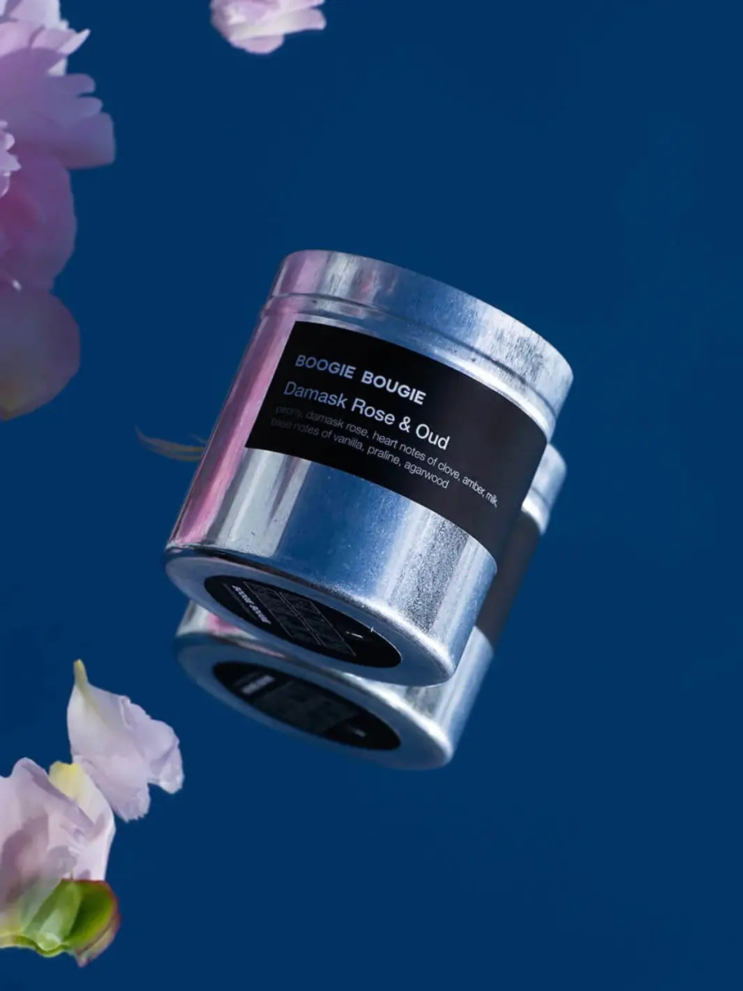 Silver Damask Rose and Our candle container with a 'Boogie Bougie' black label on a blue background with pink flowers | Twentyseven Toronto