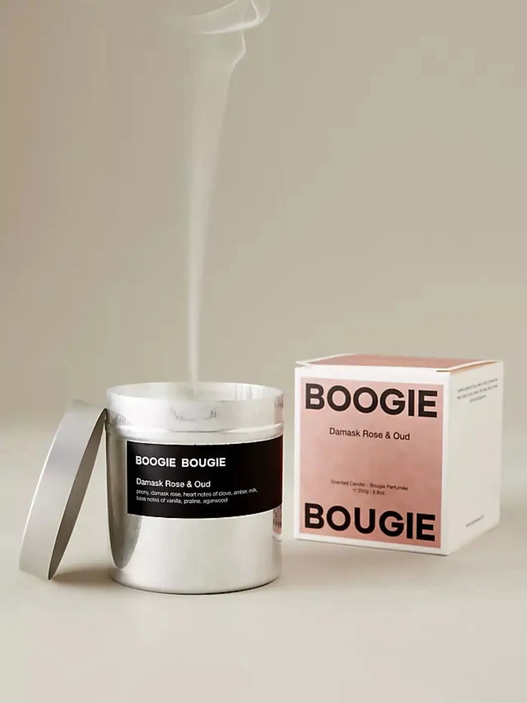 Boogie Bougie Damask Rose and Oud candle with smoke and pink packaging on a white background | Twentyseven Toronto