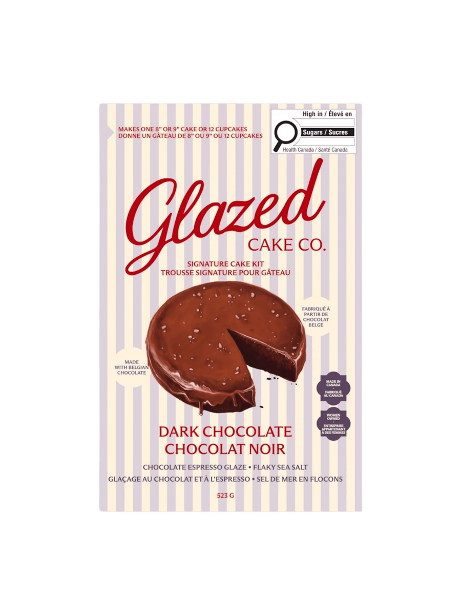 The product packaging for the Glazed Cake Co Dark Chocolate Cake Mix kit features a blue and white striped background with an illustration of a rich chocolate cake topped with flaky sea salt | Twentyseven Toronto