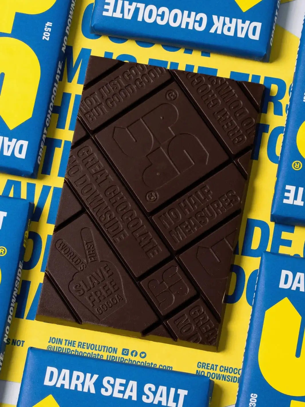 Dark sea salt dark chocolate bar with 'Up Up Chocolate' branding on a yellow and blue background | Twentyseven Toronto