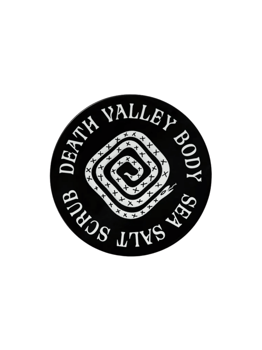 Black circular jar lid for Death Valley Nails Dead Sea Salt Scrub - Lemon + Sage + Peppermint + Earth, showcasing a white coiled snake illustration in the center | Twentyseven Toronto