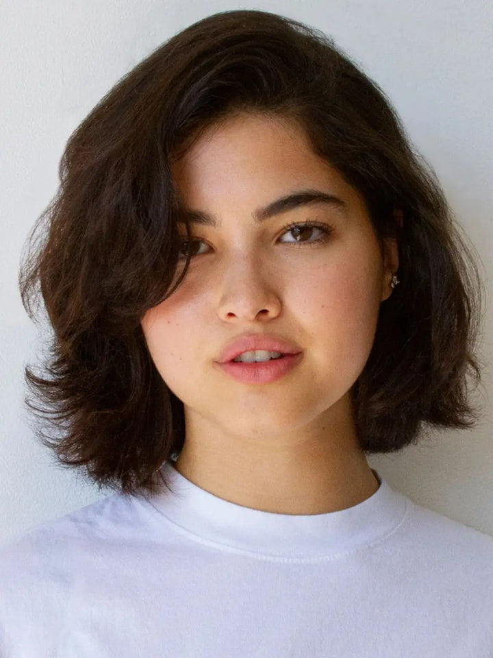 A model with a dark, voluminous bob haircut showcases texture and movement styled with R+Co SPIRITUALIZED Wet Dry Shampoo | Twentyseven Toronto