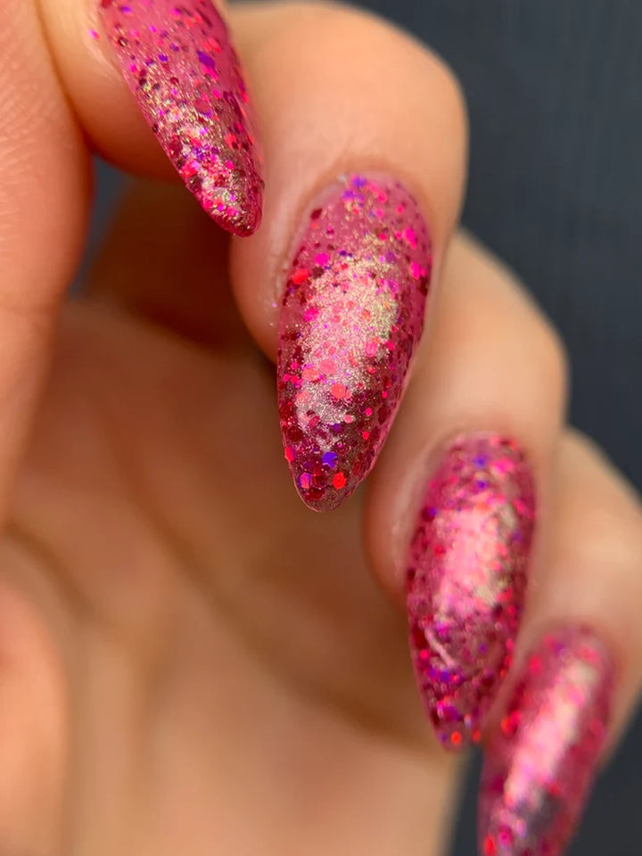 Close-up of pink multichrome nails with holographic glitter and shimmering green-gold shift | Twentyseven Toronto