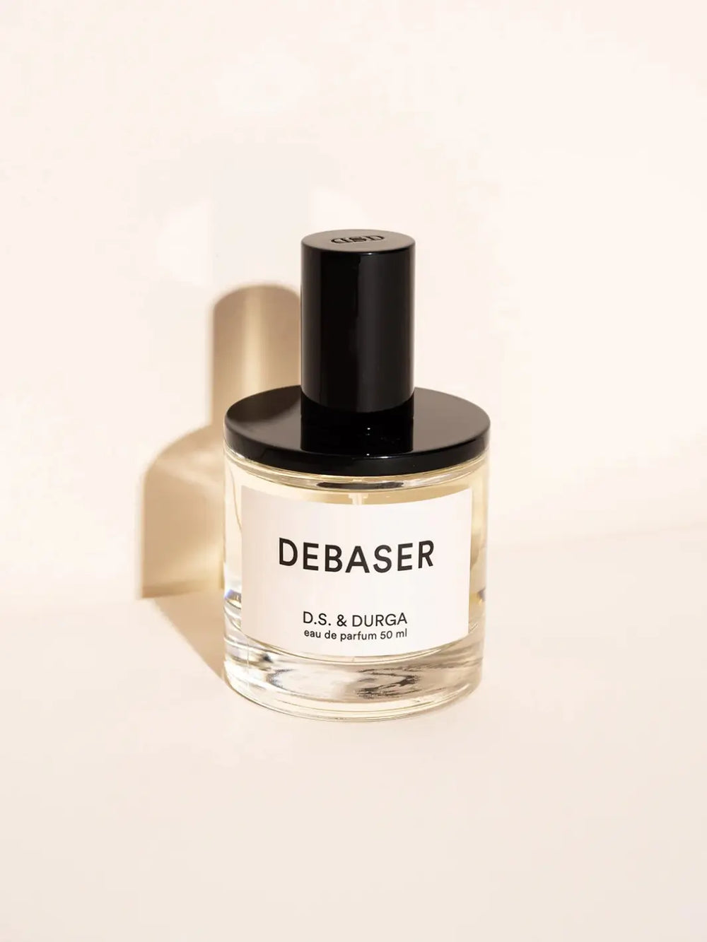 D.S. & Durga 'Debaser' 50ml perfume bottle on a beige background | Twentyseven Toronto