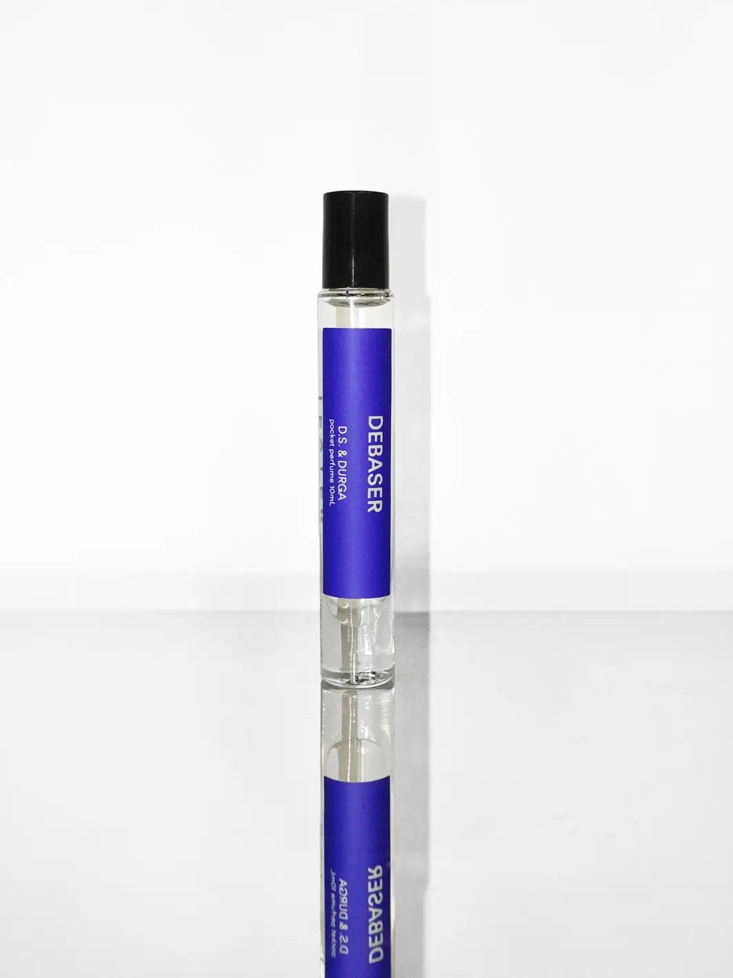 DS&Durga 10ml purple perfume roller bottle with 'Debaser' branding on a reflective surface | Twentyseven Toronto