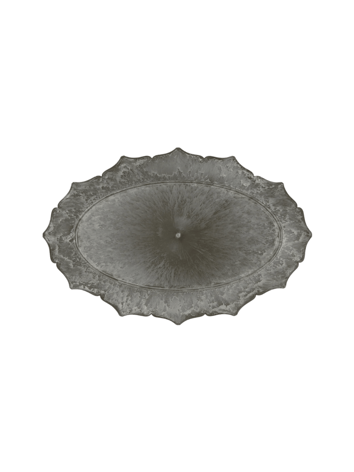 An overhead product shot of the dark, weathered Decoration Tray / Oval from Puebco, highlighting its symmetrical ornate border and central marbled patina | Twentyseven Toronto