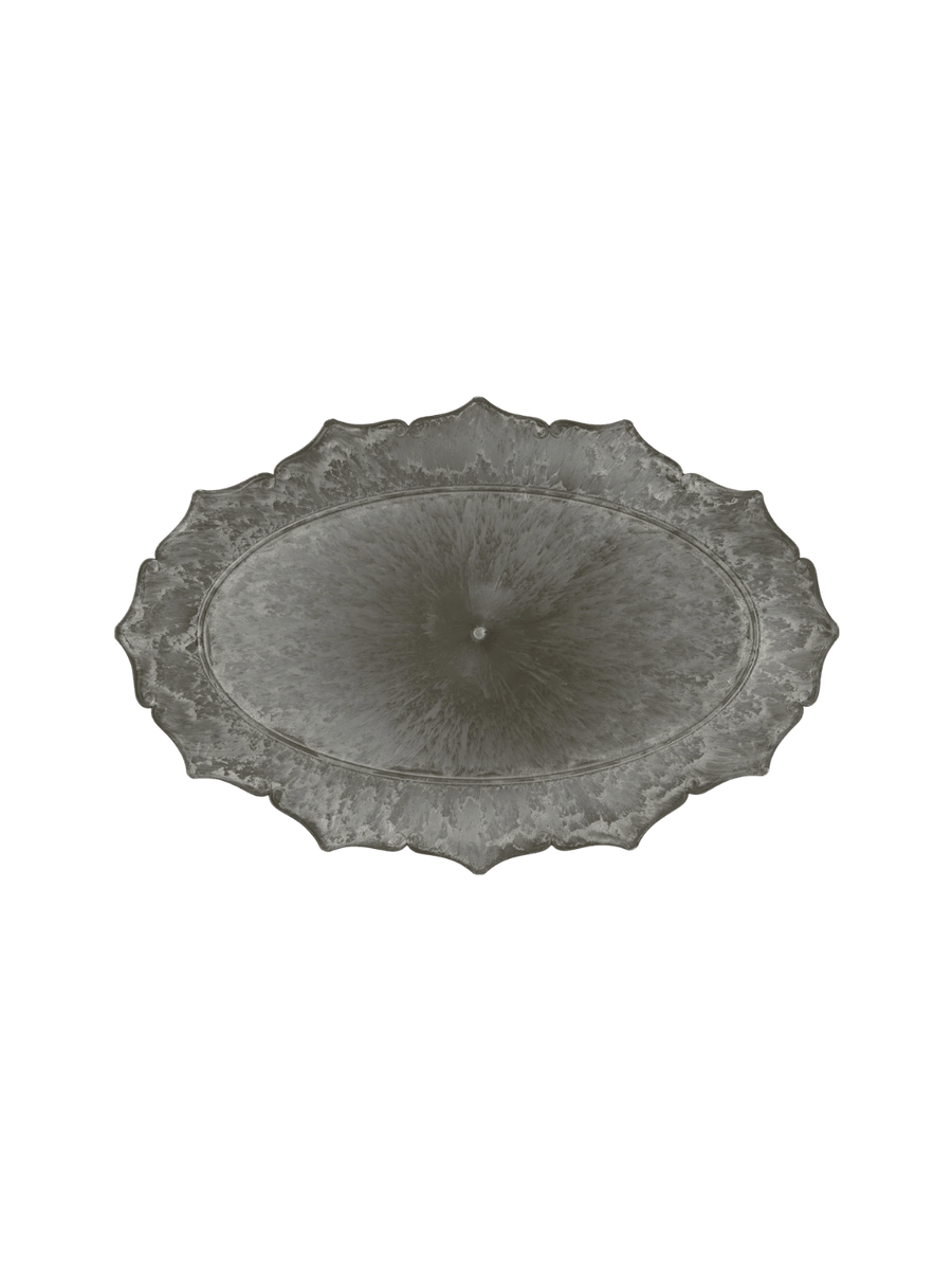 An overhead product shot of the dark, weathered Decoration Tray / Oval from Puebco, highlighting its symmetrical ornate border and central marbled patina | Twentyseven Toronto