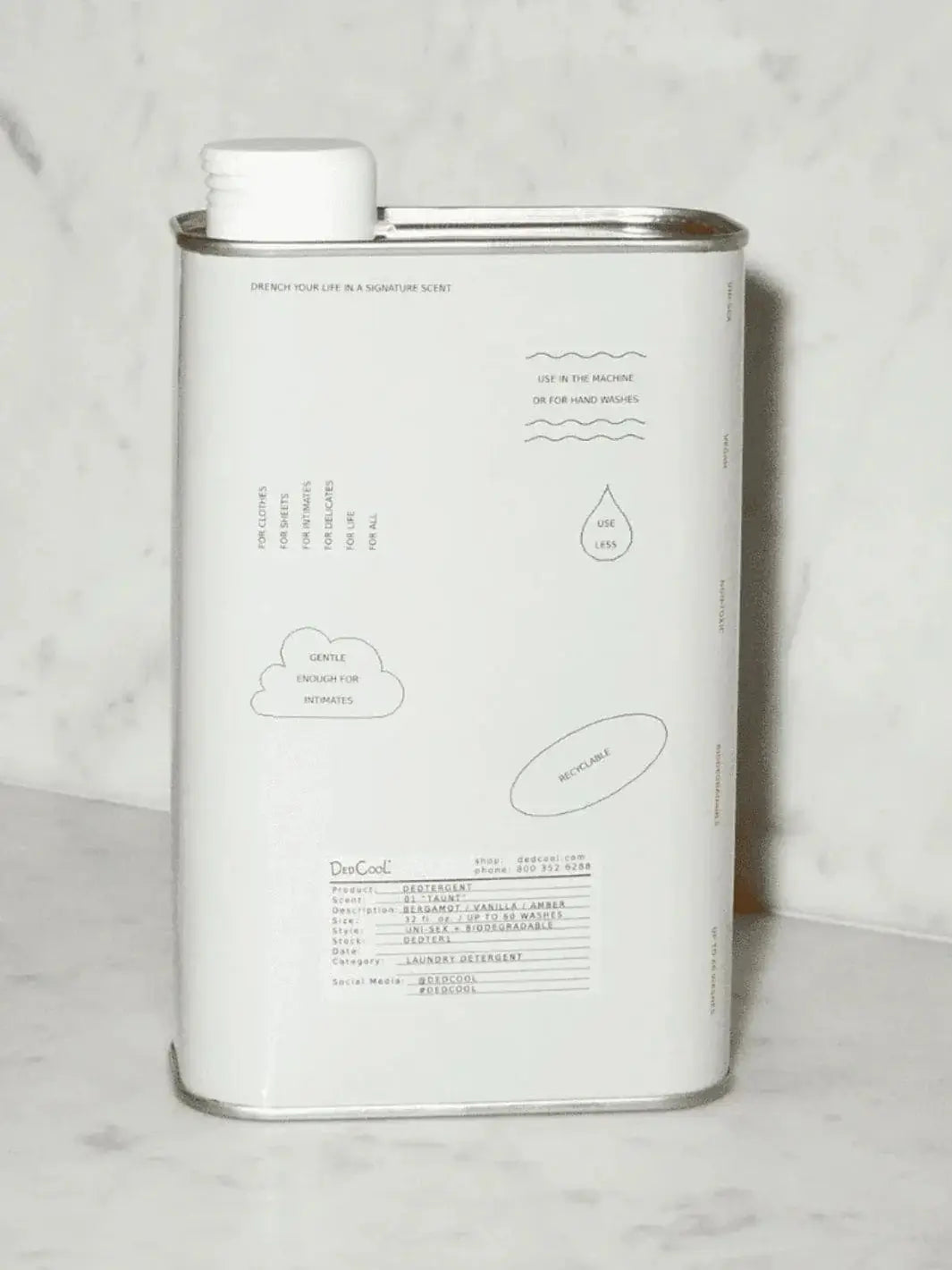 A front-facing view highlights the product information and graphics on a tin of Dedcool Dedtergent 01 "Taunt" against a marble backdrop | Twentyseven Toronto
