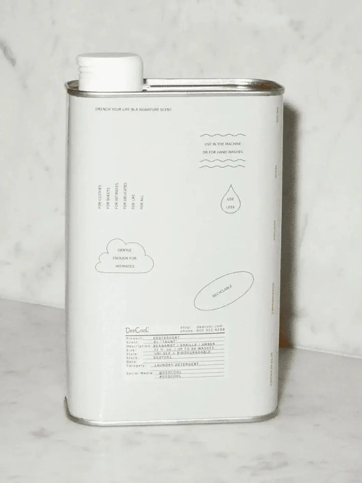 A front-facing view highlights the product information and graphics on a tin of Dedcool Dedtergent 01 "Taunt" against a marble backdrop | Twentyseven Toronto