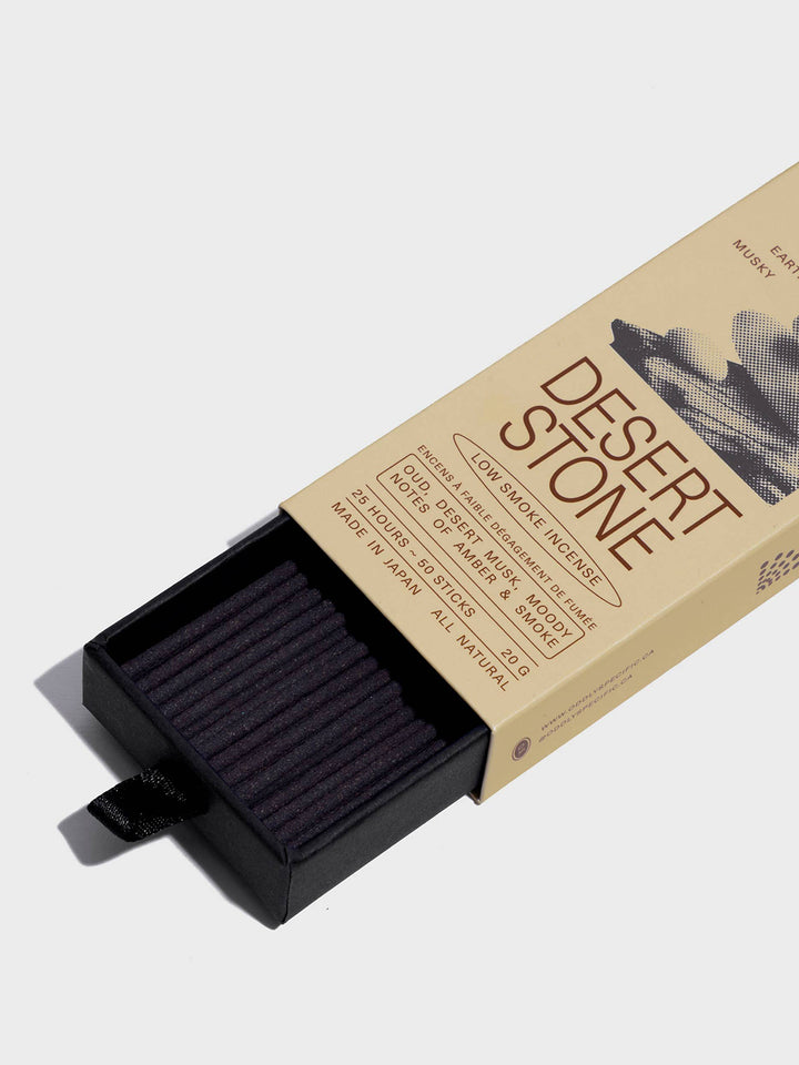 Close-up of Oddly Specific Desert Stone Low Smoke Incense showing dark incense sticks in a black pull-out tray and beige packaging with oud, desert musk and amber scent notes | Twentyseven Toronto