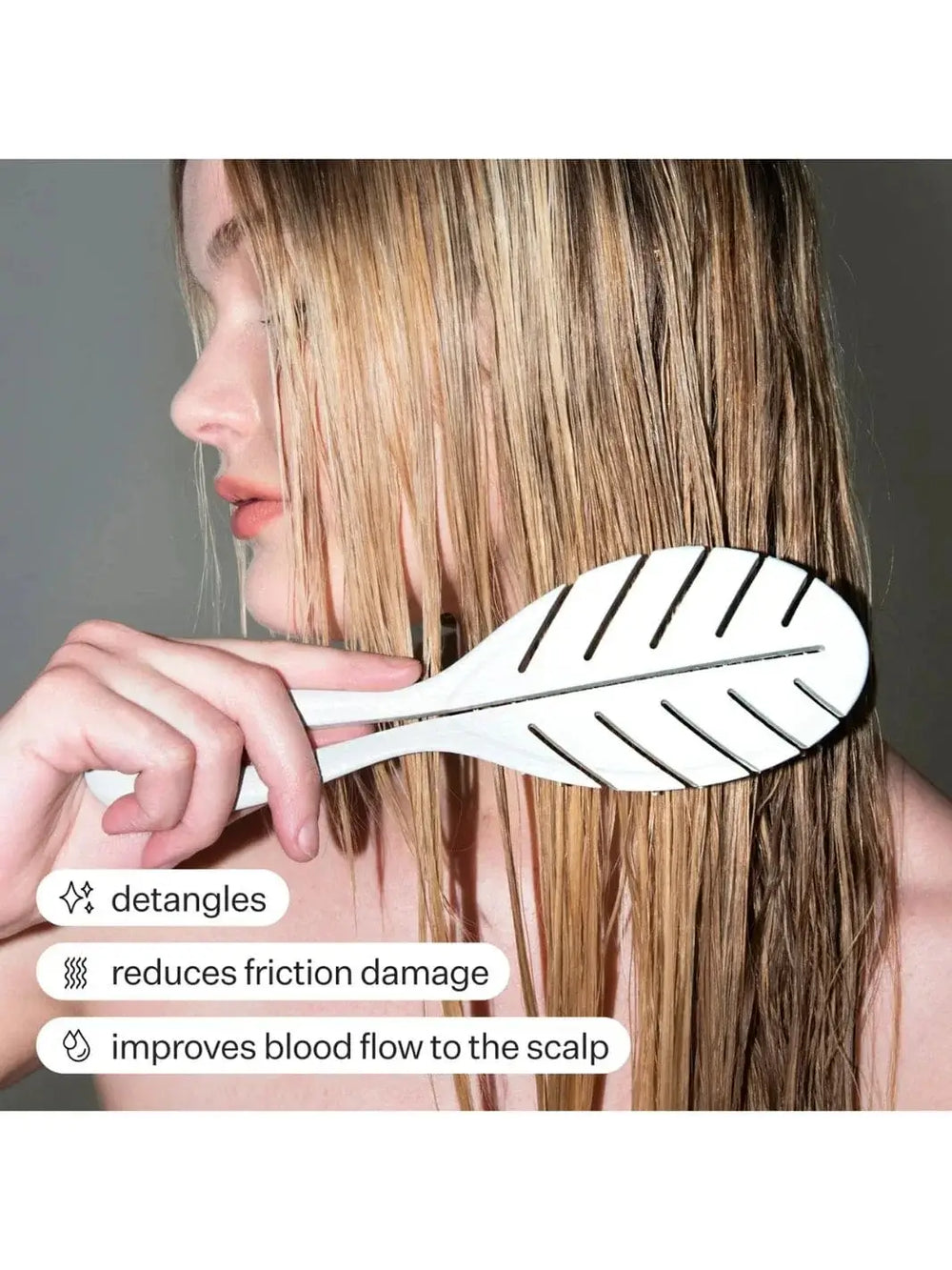 Person using a light green Act+Acre Detangling hairbrush on their blonde hair with text highlighting benefits | Twentyseven Toronto