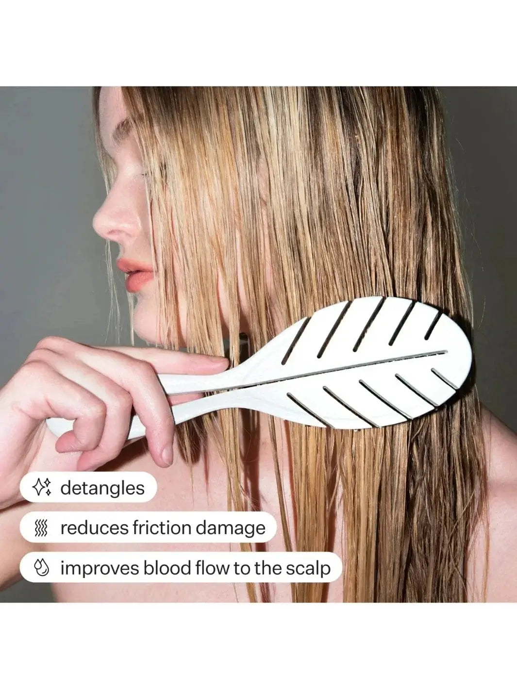 Person using a light green Act+Acre Detangling hairbrush on their blonde hair with text highlighting benefits | Twentyseven Toronto