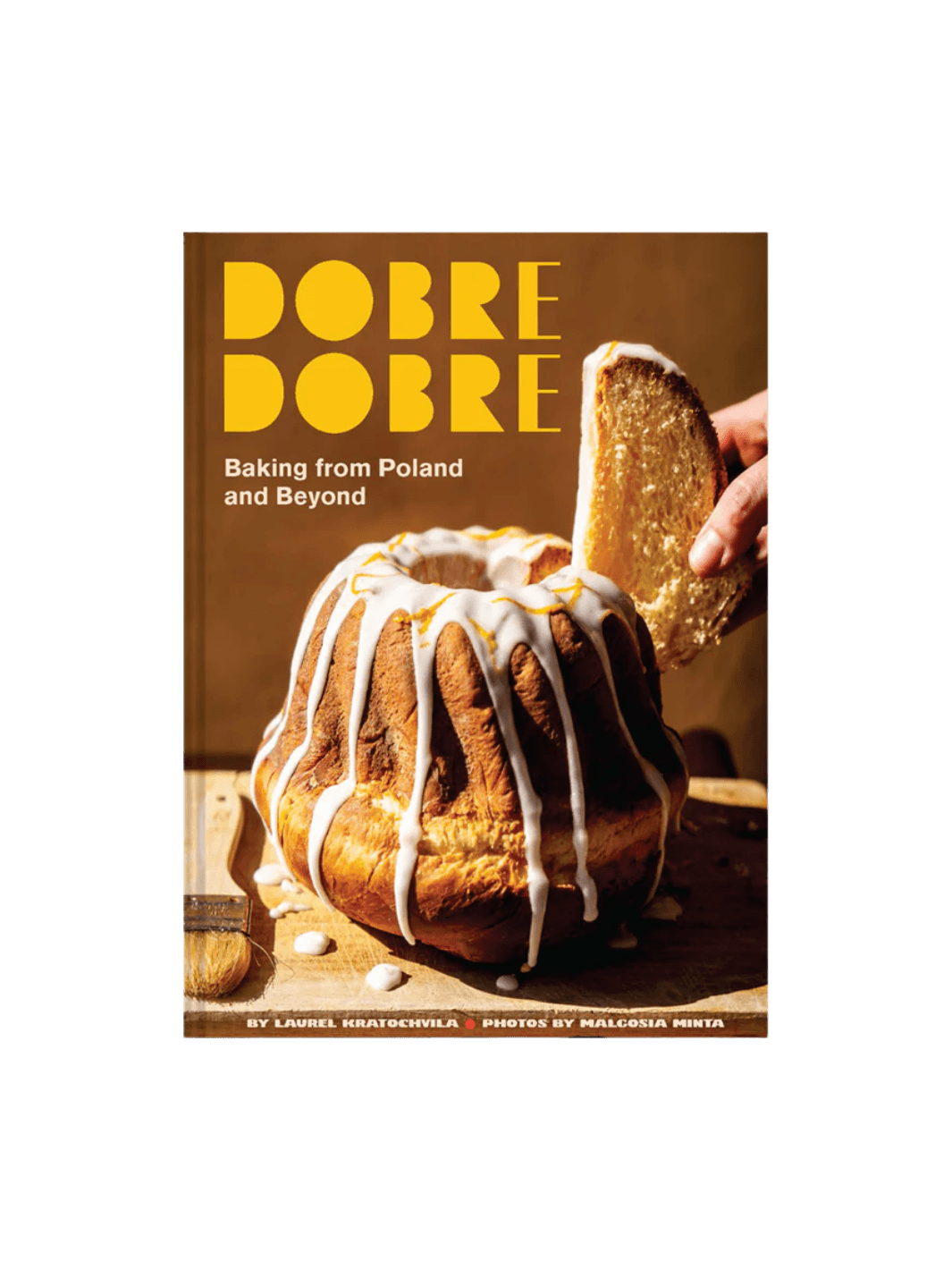 Front cover of the cookbook Dobre Dobre: Baking from Poland and Beyond by Laurel Kratochvila & Malgosia Minta, featuring a warm-toned photograph of a tall bundt cake | Twentyseven Toronto