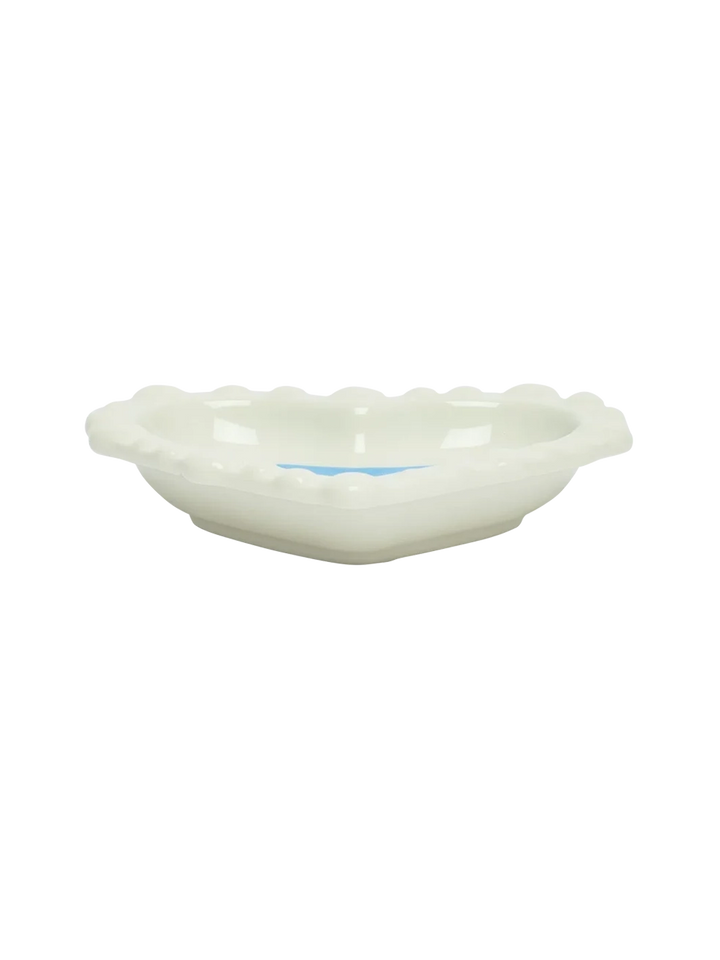 Side view of the Fishs Eddy x Susan Alexandra Duckie Dish, a heart-shaped glazed stoneware catchall with scalloped edges | Twentyseven Toronto
