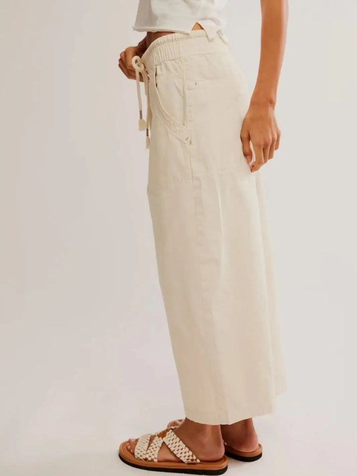 A side profile view displays the relaxed fit, stitched side seams, and comfortable elastic waistband of the off-white Free People Easy Peasy Pull-On Jeans in Irie | Twentyseven Toronto