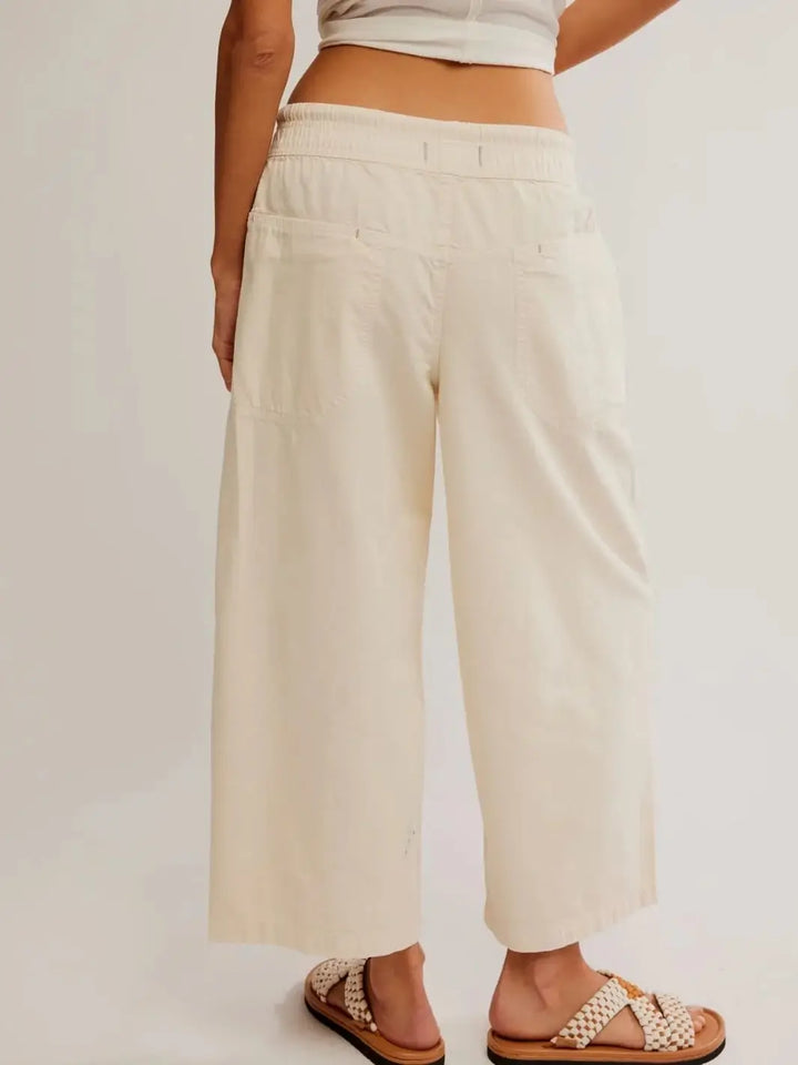 A direct rear view showcases the back patch pockets, straight-leg construction, and casual drape of the Free People Easy Peasy Pull-On Jeans in Irie | Twentyseven Toronto