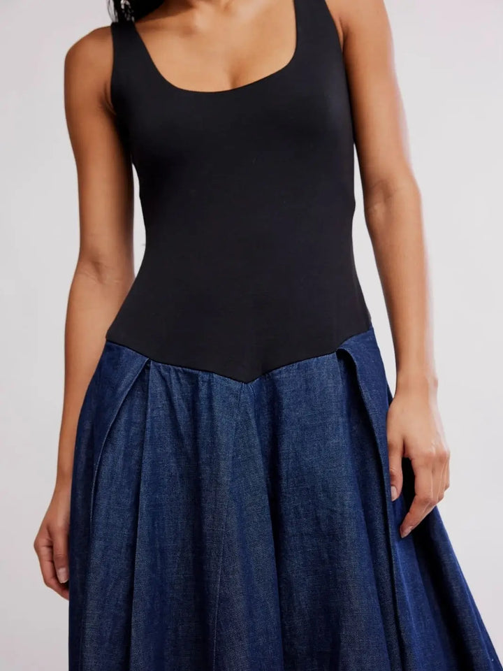 A close-up front view highlights the scooped neckline, fitted black bodice, and pleated denim waistband seam of the Free People Elio Midi in Dark Combo | Twentyseven Toronto