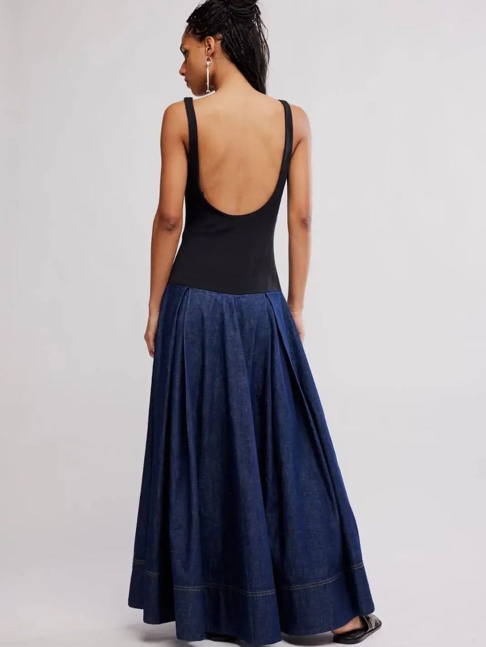 A full-length rear perspective emphasizes the low, deeply scooped back construction and detailed topstitching on the hemline of the Free People Elio Midi in Dark Combo | Twentyseven Toronto