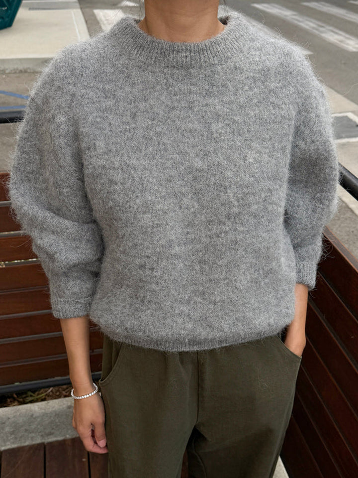 Le Bon Shoppe Elio Crew Neck Alpaca Sweater in Heather Grey styled with olive trousers, showing its relaxed boxy silhouette and ribbed crew neckline | Twentyseven Toronto