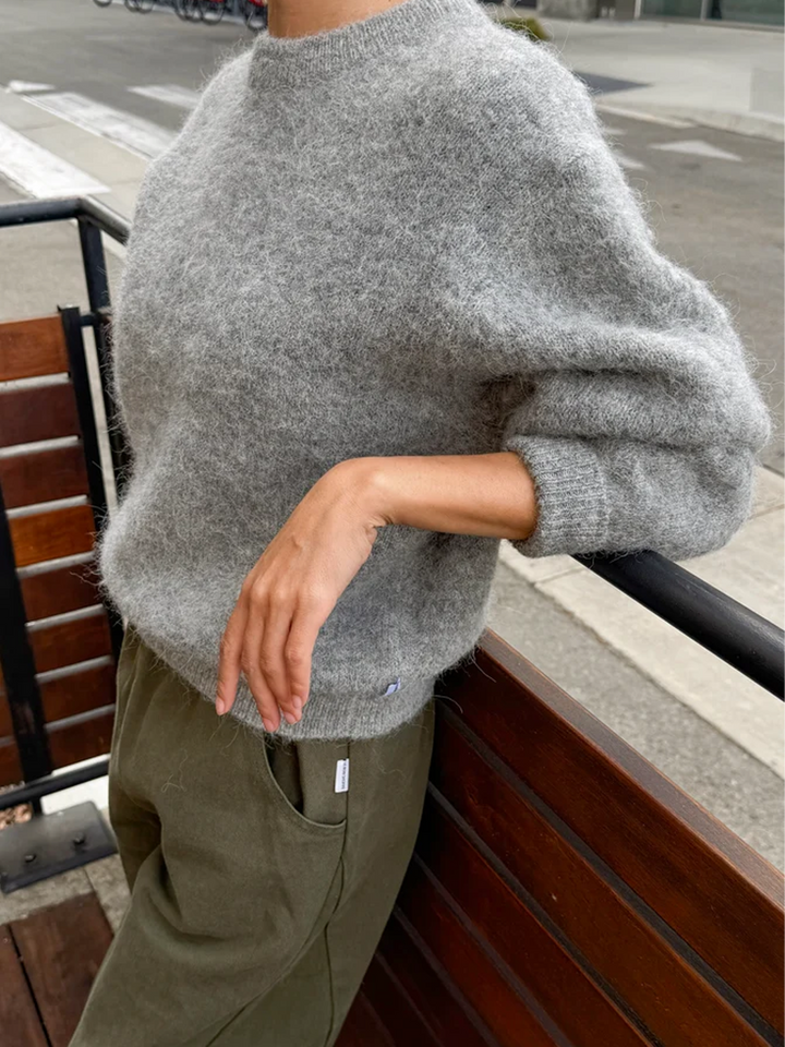 Le Bon Shoppe Elio Crew Neck Alpaca Sweater in Heather Grey shown from the side, highlighting its relaxed fit and soft alpaca-blend texture | Twentyseven Toronto