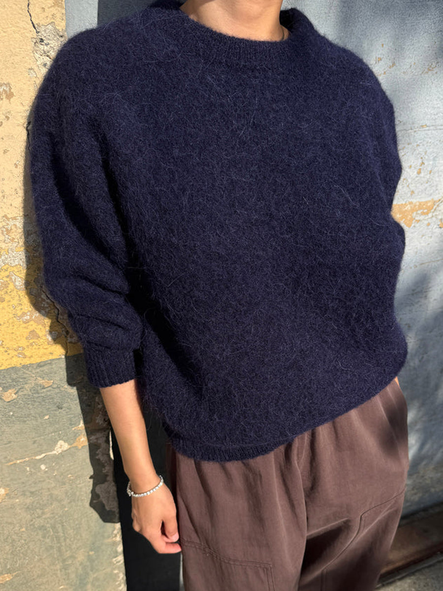 Elio Crew Neck Alpaca Sweater in Navy styled with relaxed brown trousers, showing its easy oversized fit | Twentyseven Toronto