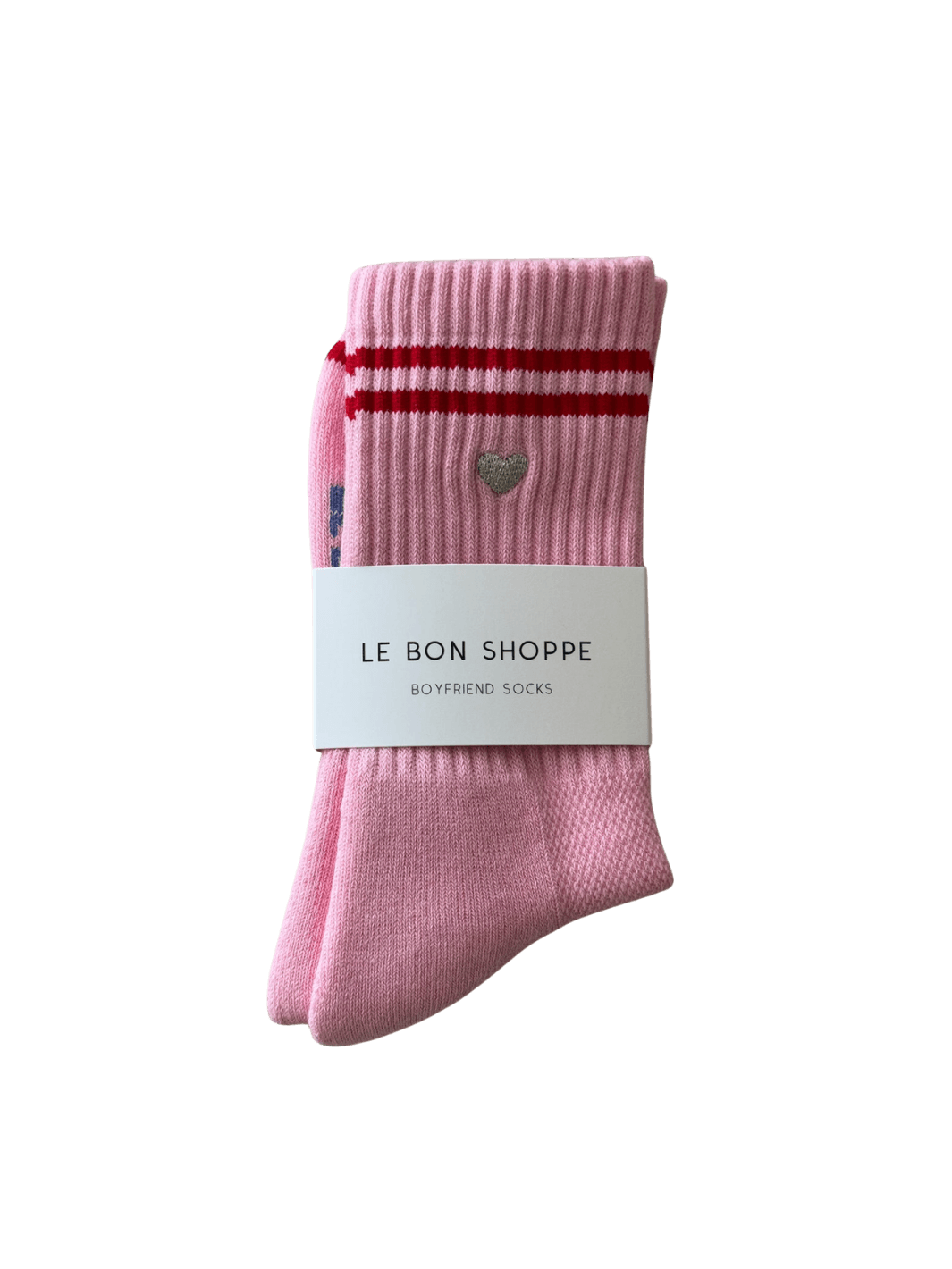 Pink 'Boyfriend Socks' with red stripes and a silver embroidered heart in 'Parchment + Heart' style with a white label featuring 'Le Bon Shoppe' branding on a transparent background | Twentyseven Toronto