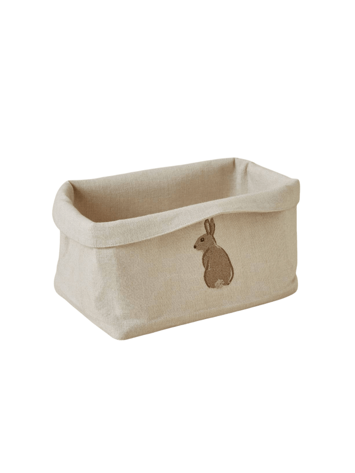 Beige fabric bread basket with a rabbit embroidery from Sylvie Thiriez on a transparent background | Twentyseven Toronto