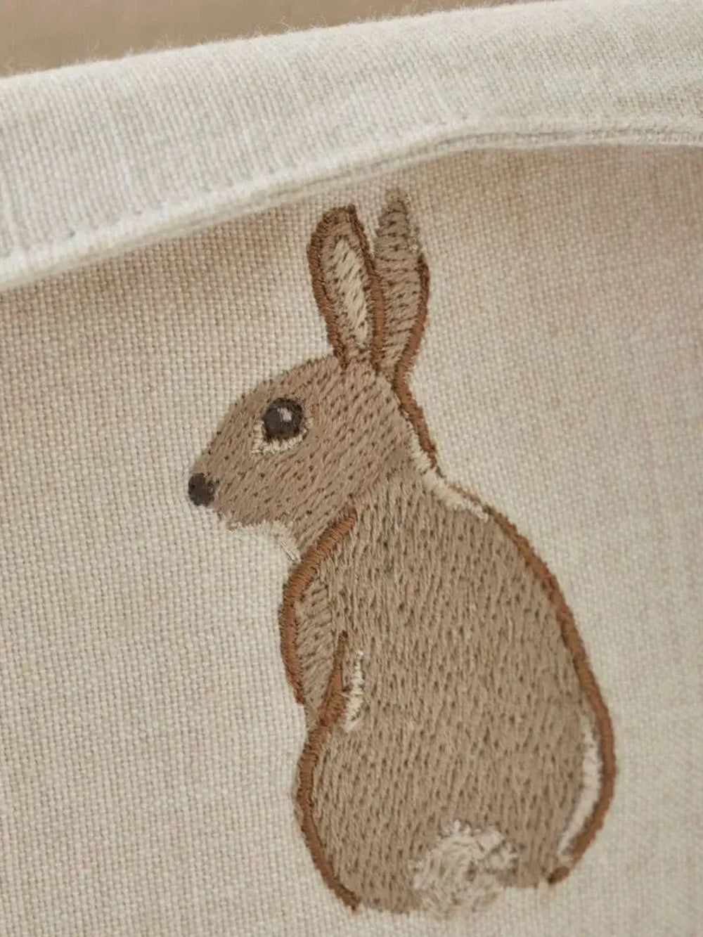 Close up of rabbit embroidery beige fabric from Sylvie Thiriez | Twentyseven Toronto