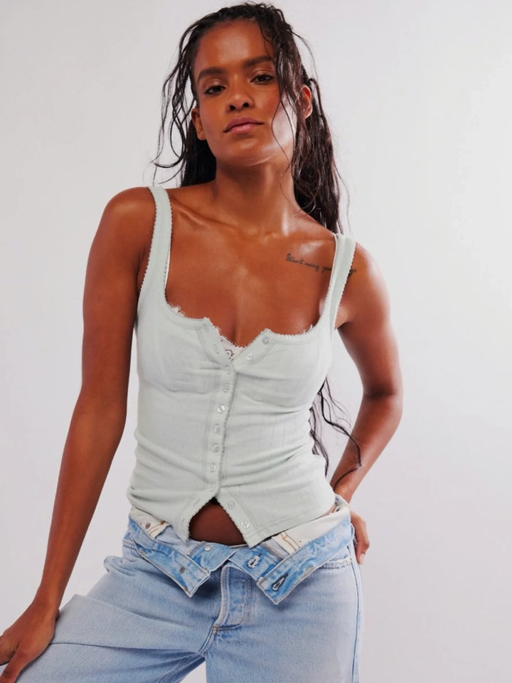 A front view from showcases the classic sweetheart neckline, slim-fitting ribbed design, and shoulder strap details and button front closure of the light blue Free People End Game Pointelle Tank - Pale Aqua | Twentyseven Toronto
