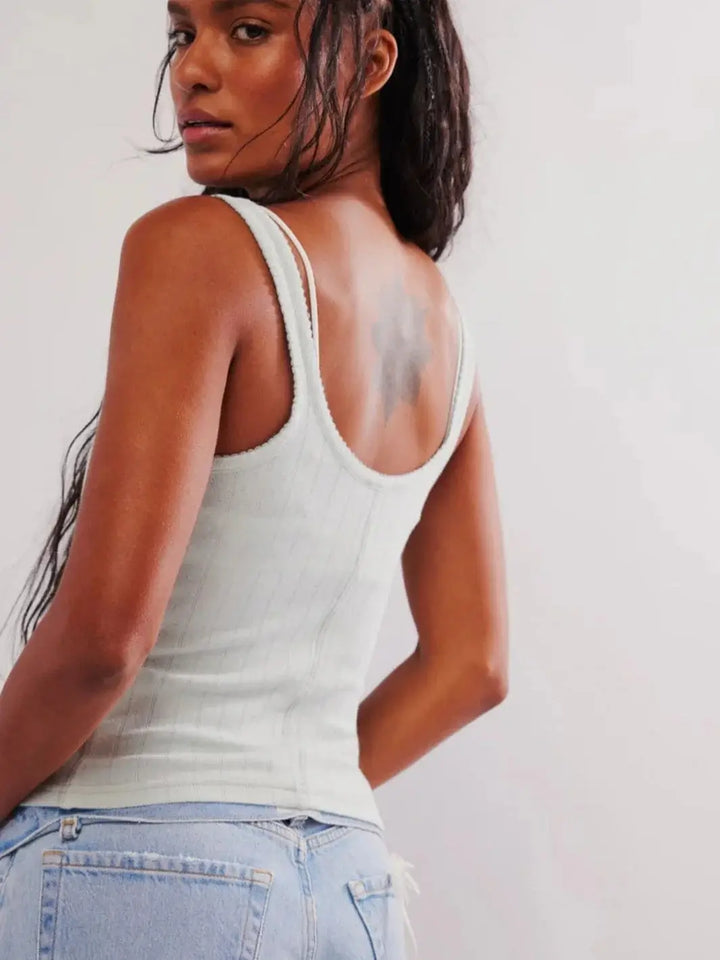  A three-quarter view from behind showcases the classic scoop neckline, slim-fitting ribbed design, and shoulder strap details of the light blue Free People End Game Pointelle Tank - Pale Aqua | Twentyseven Toronto
