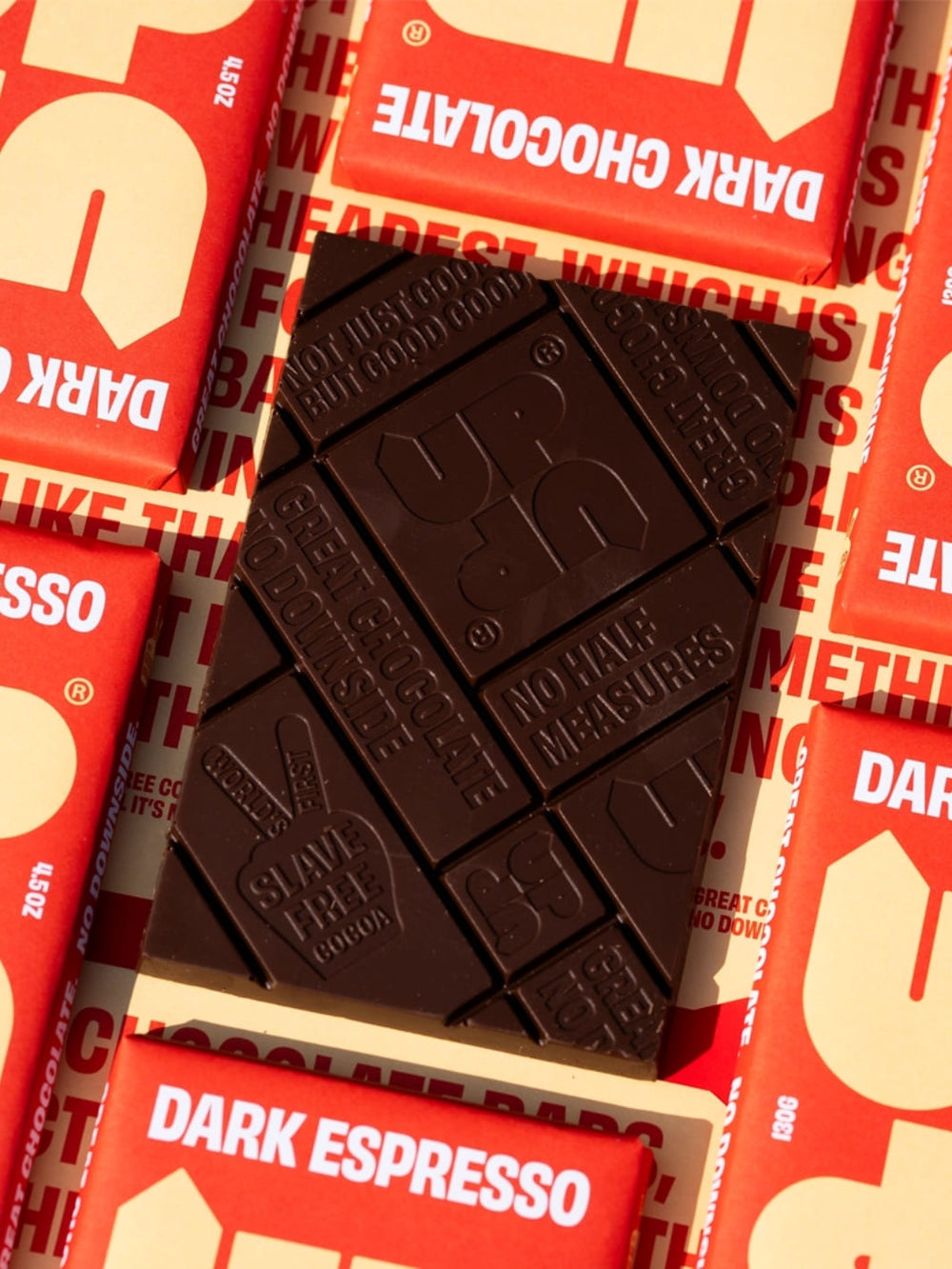 Dark chocolate espresso with 'Up Up Chocolate' branding on an orange and yellow background | Twentyseven Toronto