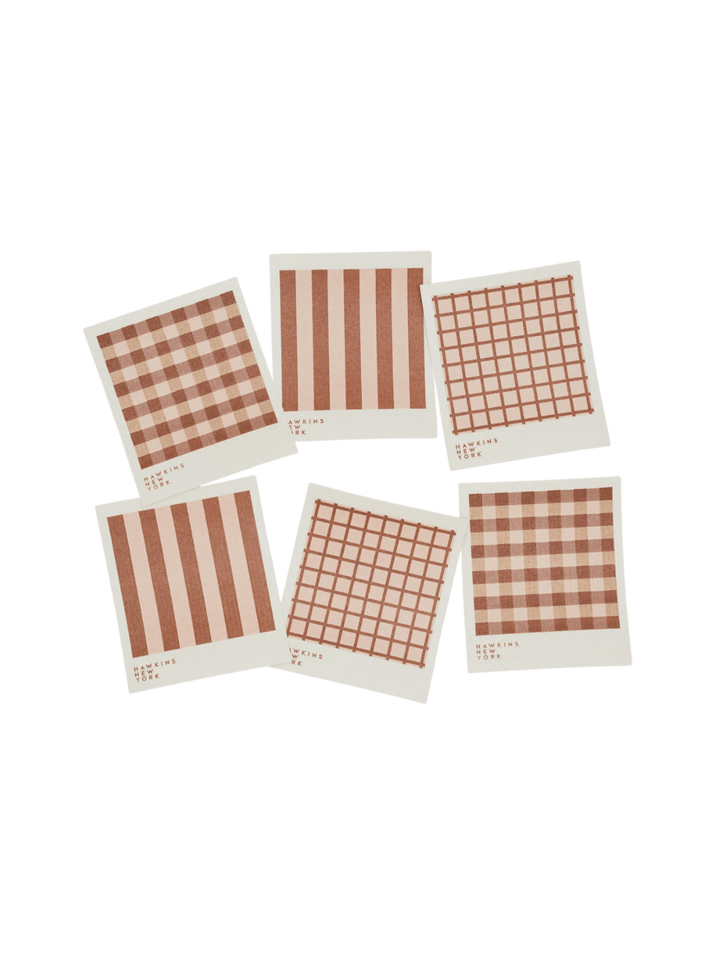 Six sponge cloths featuring assorted red plaid, striped, and windowpane patterns are arranged against a black background to showcase the complete Essential Swedish Dishcloth in Blush/Terracotta (Set of 6) from Hawkins New York | Twentyseven Toronto