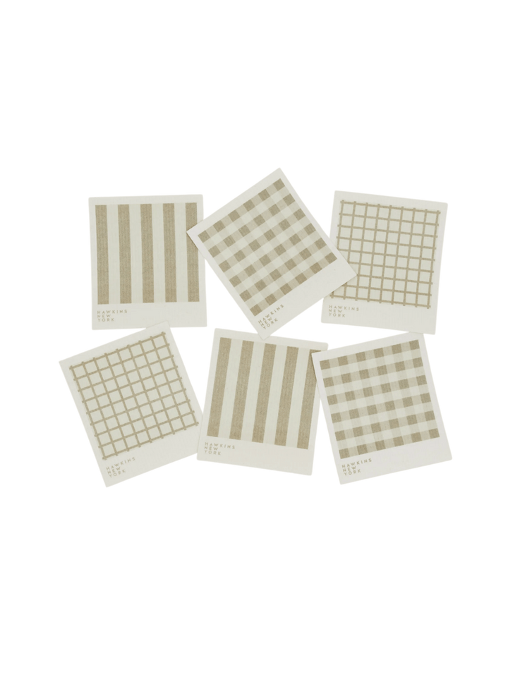 Six sponge cloths featuring assorted ivory plaid, striped, and windowpane patterns are arranged against a black background to showcase the complete Essential Swedish Dishcloth in Ivory/Flax (Set of 6) from Hawkins New York | Twentyseven Toronto